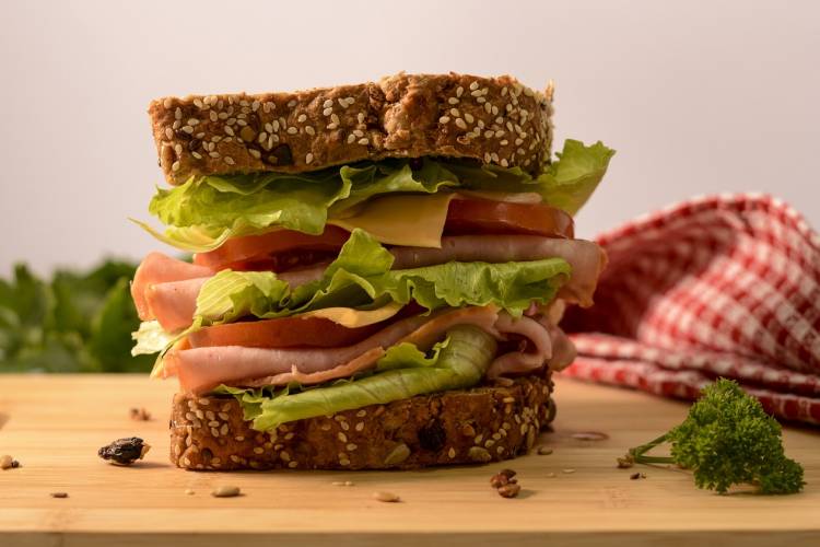 A sandwich sits on a cutting board A sandwich sits on a cutting board