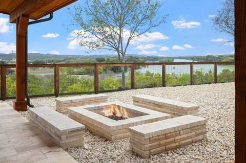 an upscale outdoor fireplace on a stone deck