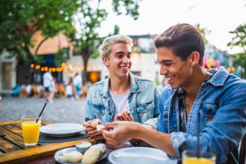 A couple enjoys a meal in a popular square