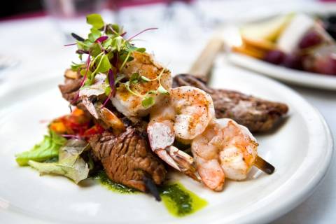 Seafood surf 'n turf - a skewer of jumbo strip served atop a piece of marinated steak