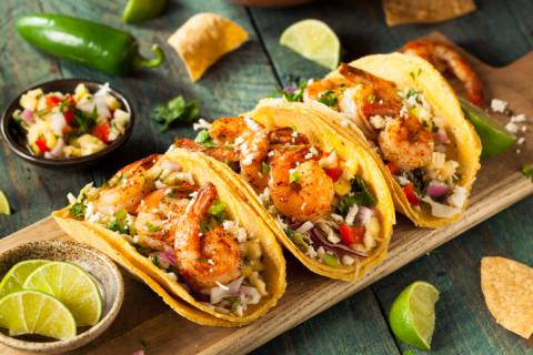 Mexican food a trio of shrimp tacos in yellow corn tortillas
