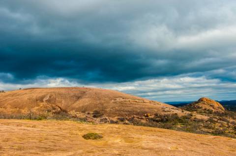 Enchanted rock near Fredericksburg, Texas with a storm looming overhead