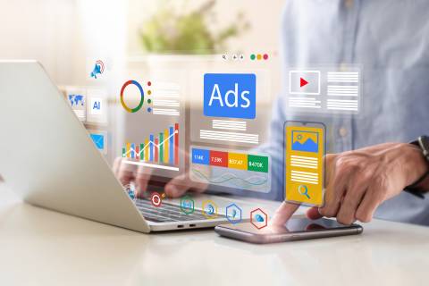 digital marketing services hands typing on a laptop with a graphical overlay of marketing charts